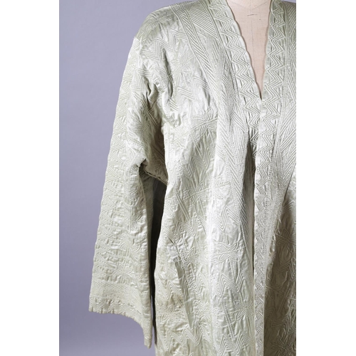 198 - An antique Persian quilted robe, full length, the cotton exterior in pale green, the inside in cream... 