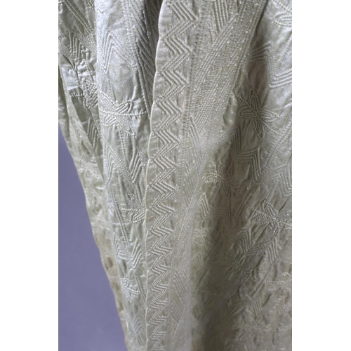 198 - An antique Persian quilted robe, full length, the cotton exterior in pale green, the inside in cream... 