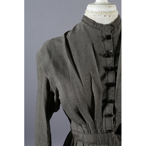 267 - A simple mid-19th century grey wool dress with fitted bodice, gathered skirt, the bodice lined in cr... 