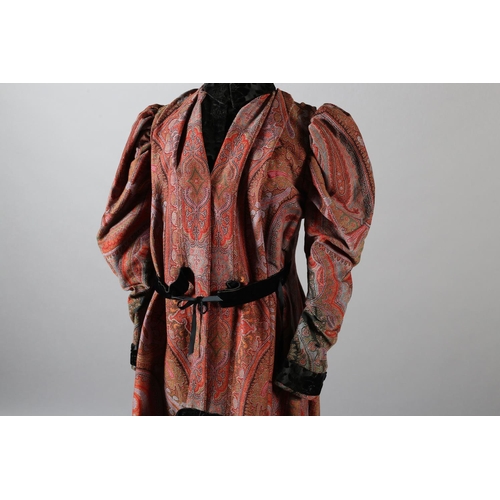 273 - A mid-19th century coat, made from a good woven paisley shawl, gigot sleeves, the collar, inside bod... 