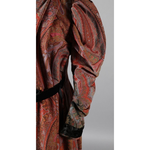 273 - A mid-19th century coat, made from a good woven paisley shawl, gigot sleeves, the collar, inside bod... 