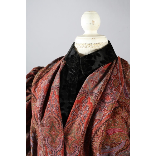 273 - A mid-19th century coat, made from a good woven paisley shawl, gigot sleeves, the collar, inside bod... 