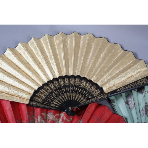 28 - Four large late 19th century fans, all with wood montures, three with a fabric leaf, one of paper, a... 