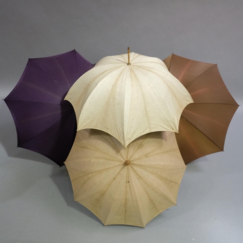 294 - A selection of parasols to include a plum silk example, the shaft of plain wood, the knop of cloison... 