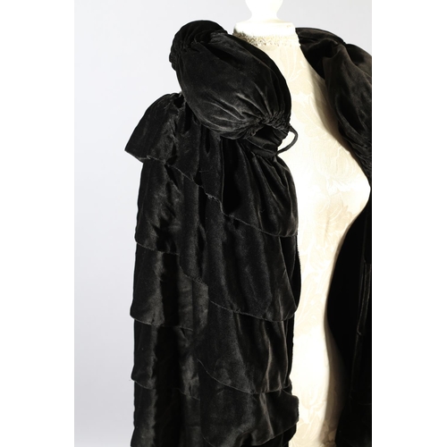 299 - A 1920’s opera cape in soft and fluid chocolate velvet, black silk lining, ruched collar with top bu... 