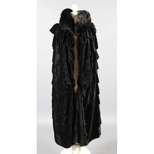 299 - A 1920’s opera cape in soft and fluid chocolate velvet, black silk lining, ruched collar with top bu... 