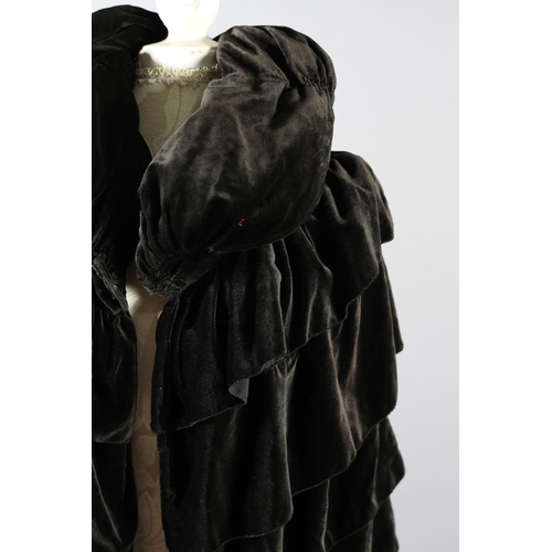 299 - A 1920’s opera cape in soft and fluid chocolate velvet, black silk lining, ruched collar with top bu... 