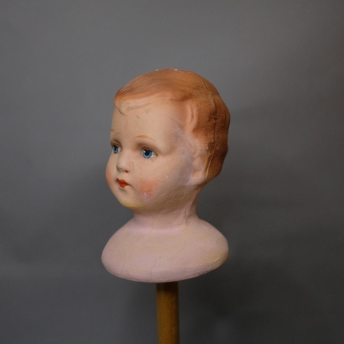 308 - 1920’s hat stands, painted wood, one surmounted with a moulded plaster head, the face with blue eyes... 