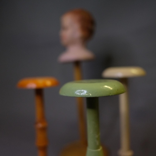 308 - 1920’s hat stands, painted wood, one surmounted with a moulded plaster head, the face with blue eyes... 