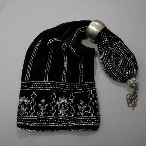 321 - An unusually large miser’s purse in black velvet, lavishly embroidered in cut steel beads, one large... 