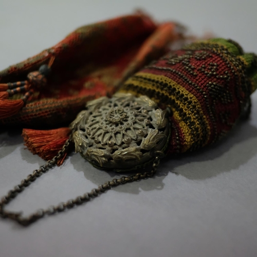 322 - Two unusual 19th century bags, the first embroidered with metal beads and topped with a round metal ... 