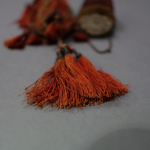 322 - Two unusual 19th century bags, the first embroidered with metal beads and topped with a round metal ... 