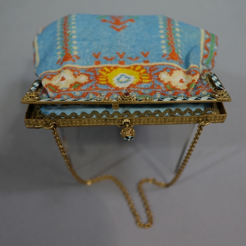 323 - A good woven beaded evening bag, circa 1900, the metal frame enamelled in black, white and turquoise... 