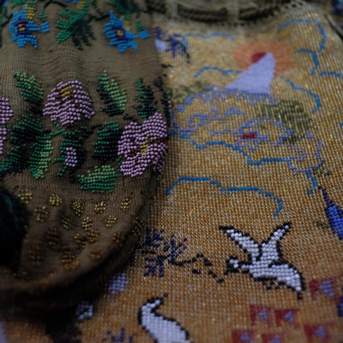 325 - Four c 1920’s woven beaded bags, the first with a scene of white birds in flight, a tree and the sun... 