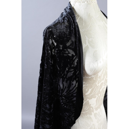 355 - Two 20th century black cut velvet garments, one a draped top, hip-length, the other a fringed shawl,... 