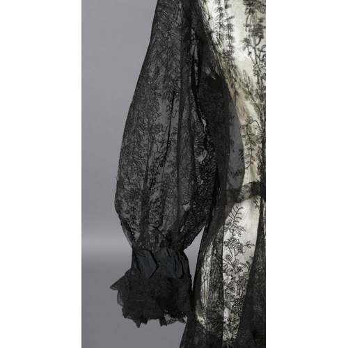 356 - A black machine lace long sleeved coat, 19th century, most likely formed from a large shawl, the cuf... 