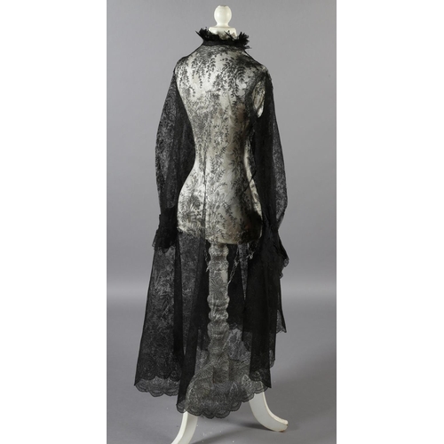 356 - A black machine lace long sleeved coat, 19th century, most likely formed from a large shawl, the cuf... 