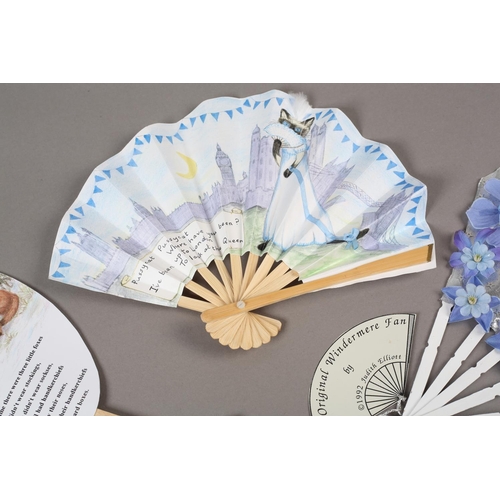 49 - Judith Elliott: a fixed fan depicting three little foxes, with a poem, signed and dated 1998; a fan ... 