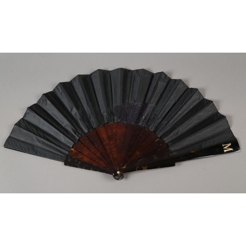 54 - A c.1890’s gauze fan painted with butterflies, signed “Antoinette”, the leaf mounted on blonde torto... 