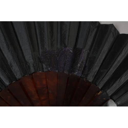 54 - A c.1890’s gauze fan painted with butterflies, signed “Antoinette”, the leaf mounted on blonde torto... 