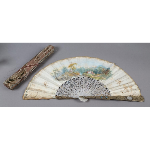 56B - An ornate mid-19th century mother of pearl fan, the guards entirely of carved and pierced gilt metal... 