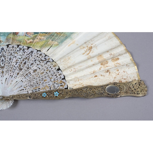 56B - An ornate mid-19th century mother of pearl fan, the guards entirely of carved and pierced gilt metal... 