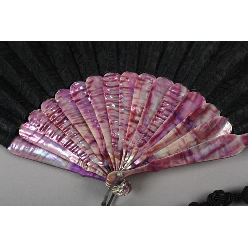 78 - c.1880’s a mother of pearl fan, monture dyed in shades of purple, the black silk leaf overlaid with ... 