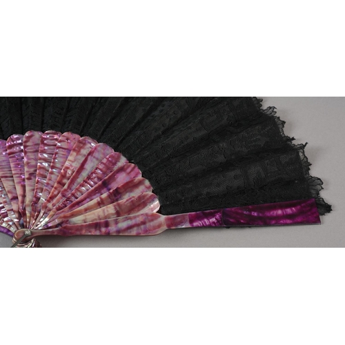 78 - c.1880’s a mother of pearl fan, monture dyed in shades of purple, the black silk leaf overlaid with ... 