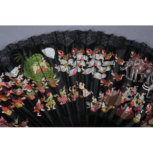 124 - A good black silk fan from Burma, c 1880’s, colourfully painted with figures and elephants, the foca... 