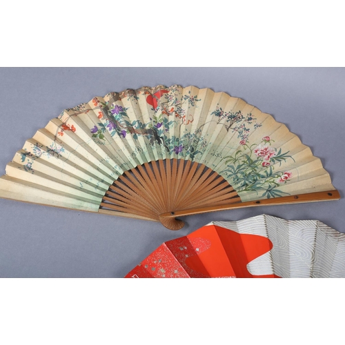 128 - Two Japanese fans, the first with wood monture, the guards inset with shibayama insects, three diffe... 