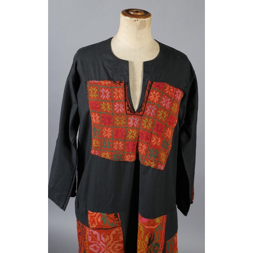 197 - A middle eastern robe in black with panels of vibrant embroidery