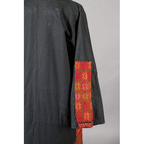 197 - A middle eastern robe in black with panels of vibrant embroidery