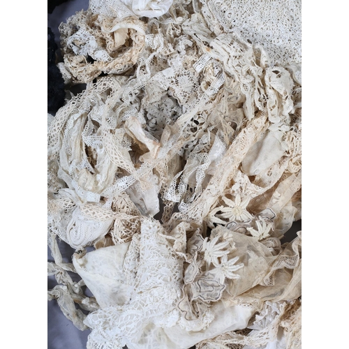 206 - Antique lace: a large quantity of mainly Edwardian cream handmade and chemical lace fragments, floun... 