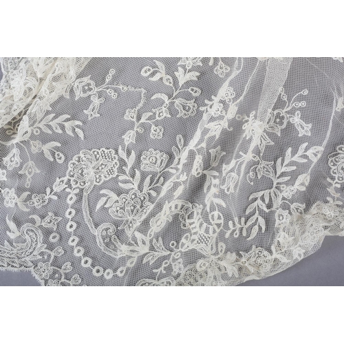 228 - Antique lace: a trained skirt panel in Limerick lace, constructed to cross over, with shaped sides; ... 