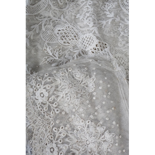 228 - Antique lace: a trained skirt panel in Limerick lace, constructed to cross over, with shaped sides; ... 