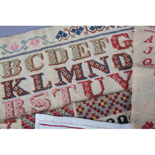 229 - Four needlework alphabet samplers, worked in colour, European, the first dated 1899 by M S Schreiber... 