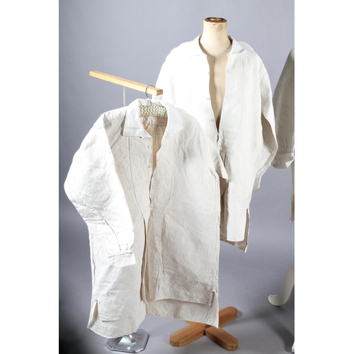 252 - Four French heavy linen gentlemen’s shirts, very long, 19th century, all with long sleeves, cotton c... 