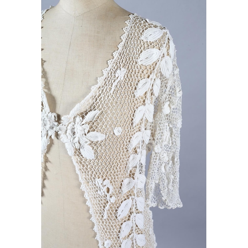 268 - Irish Crochet short sleeved, long jacket, Edwardian, designed mainly with meandering leaves interspe... 