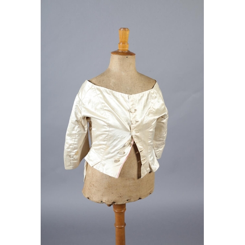 272 - A two-piece cream silk satin ensemble, comprising skirt and bodice, both lined in a pale salmon cott... 