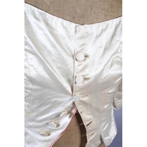 272 - A two-piece cream silk satin ensemble, comprising skirt and bodice, both lined in a pale salmon cott... 