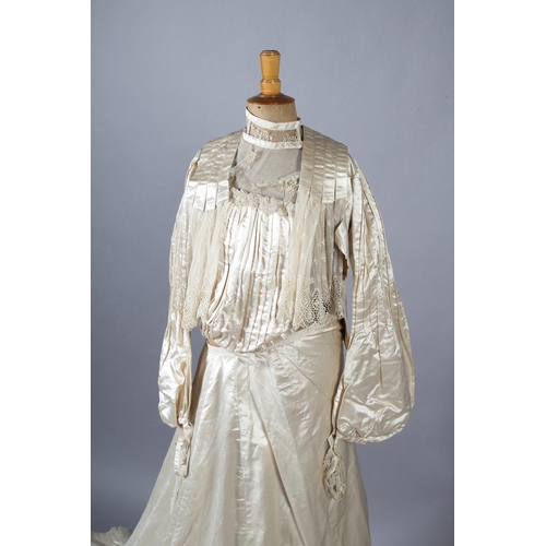 272 - A two-piece cream silk satin ensemble, comprising skirt and bodice, both lined in a pale salmon cott... 