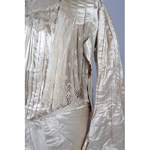 272 - A two-piece cream silk satin ensemble, comprising skirt and bodice, both lined in a pale salmon cott... 