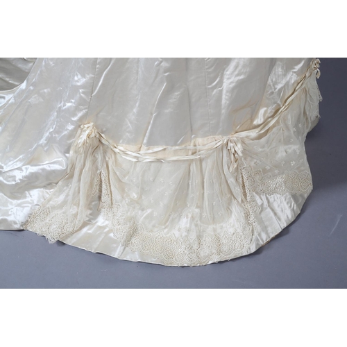 272 - A two-piece cream silk satin ensemble, comprising skirt and bodice, both lined in a pale salmon cott... 