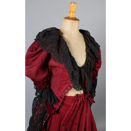 282 - c.1900, a bodice and skirt ensemble, in ruby grosgrain, trimmed with black machine lace, the bodice ... 