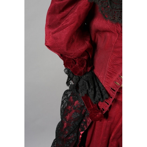 282 - c.1900, a bodice and skirt ensemble, in ruby grosgrain, trimmed with black machine lace, the bodice ... 