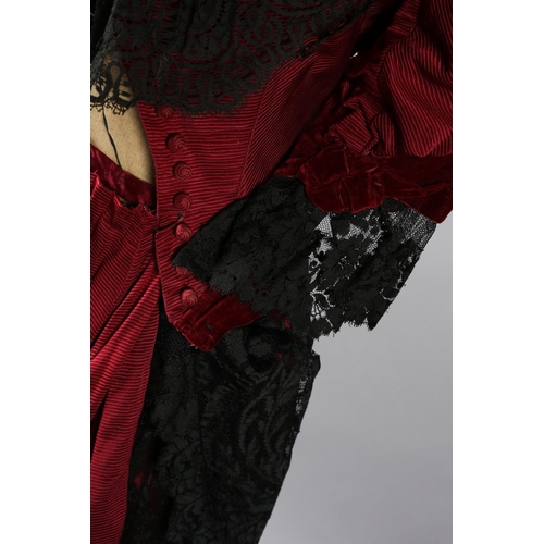 282 - c.1900, a bodice and skirt ensemble, in ruby grosgrain, trimmed with black machine lace, the bodice ... 