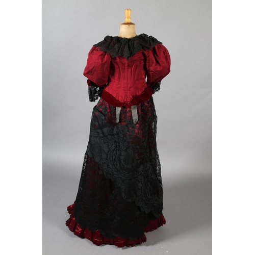 282 - c.1900, a bodice and skirt ensemble, in ruby grosgrain, trimmed with black machine lace, the bodice ... 