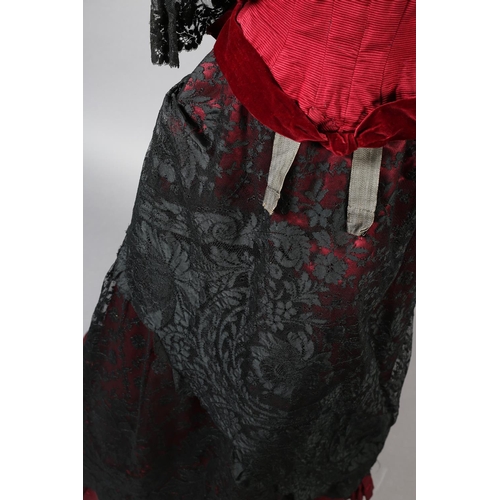 282 - c.1900, a bodice and skirt ensemble, in ruby grosgrain, trimmed with black machine lace, the bodice ... 