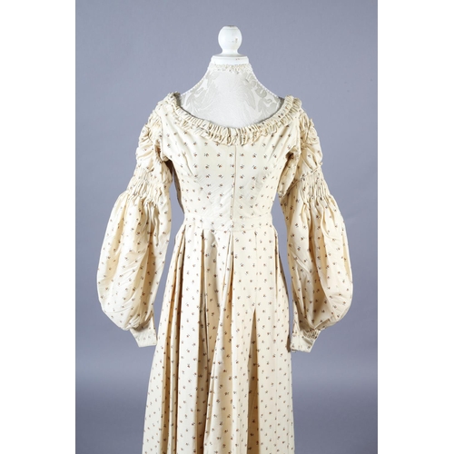 286 - A fine wool gown, 19th century, cream, printed with tiny flowers and leaves, gathering to the neck, ... 