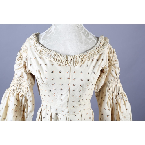 286 - A fine wool gown, 19th century, cream, printed with tiny flowers and leaves, gathering to the neck, ... 